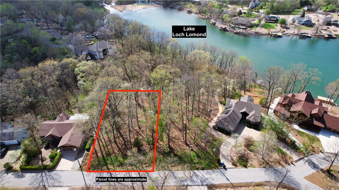 Discover this exceptional 0.30-acre lot on Stucky Lane in beautiful Bella Vista, offering a stunning year-round view of Lake Loch Lomond. This prime homesite backs to POA-owned common property, providing added privacy and open space behind while preserving the natural beauty of the surrounding landscape. The adjacent POA land allows convenient pedestrian access to nearby Lake Loch Lomond for recreation and enjoyment. Ideally suited for building your dream home in a desirable Bella Vista community, this serene site combines breathtaking lake views, natural beauty, and convenient lake access. A rare opportunity!