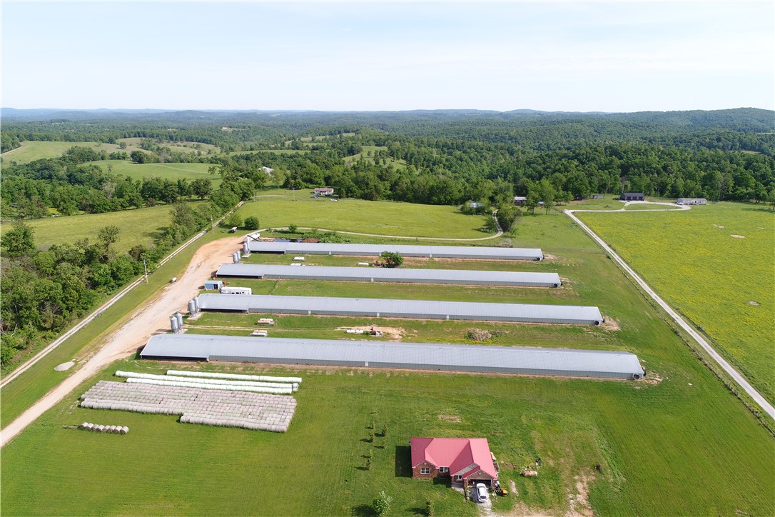 This poultry operation features four 43' x 500' houses with over $150,000 in recent retrofits, ensuring peak efficiency. The farm is currently on a George’s contract with two years remaining, generating a consistent $252,000 in gross annual income across five guaranteed flocks of 7.5 lb. birds.  Upgrades include Rotem Controllers with digital backups, Ag Innovation lighting, and new turbo feeders installed, alongside new cables and vent doors. The facility is further optimized with new wiring and sensors for every stove to maintain climate control. Houses have recently been improved with new cool cells on half of each house to be finished with cool cells on the remainder this summer.  Also situated on the property is a 1,650 sq. ft. home featuring 3 bedrooms, 2 baths, and a durable metal roof installed in 2017.   For added value, a brand-new HVAC unit will be installed in the residence prior to closing. This property offers the perfect blend of a modernized production facility and a well-maintained family home