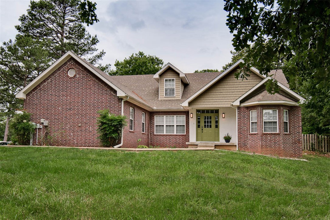 Rare opportunity to own a 4-bedroom, 3-bath, mostly brick home on a large lot in one of Bella Vista’s most sought-after biking locations. Enjoy easy access to trails near the home & a short bike ride to Tunnel Vision Trail. Just minutes from Tanyard Creek, OZ Trails bike park, Kingsdale Rec Complex & golf course. This home offers the perfect blend of comfort, location, and connection to nature. The versatile floor plan features 3 bedrooms and 2 baths on the main level plus an upstairs bedroom with an additional full bath. Upstairs also includes a spacious bonus room and storage room. A separate bonus room on the main level provides an ideal space for a home office, library, hobby room, or flex space. Major updates offer peace of mind, with the roof and key systems all less than six years old. Dual HVAC units provide efficient comfort, with separate systems serving the main and upper levels. If you’re looking for space, flexibility, and easy access to Bella Vista’s renowned trail system, this home is a must-see.