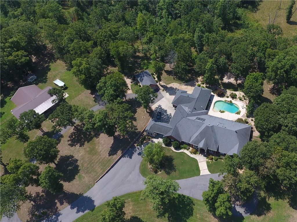 Private 24 acre Bentonville Estate located on stunning hilltop setting minutes from Downtown! Long winding private driveway leads to the 6800 sfeet estate home on one level, 7 BRs, 5.5 Baths. A True gourmet chef's kitchen like no other! Featuring Double Islands, SubZero Refrigerator, Wolf Commercial Grade Appliances. Saltwater pool, Media Room, Exercise Room, Study. Detached 4 car garage and 60 x 60 horse barn with workshops. Full spec sheet of whole house amenities and upgrades available upon request. Shown by Appointment Only. See Matterport Link for Virtual Walk through Tour!