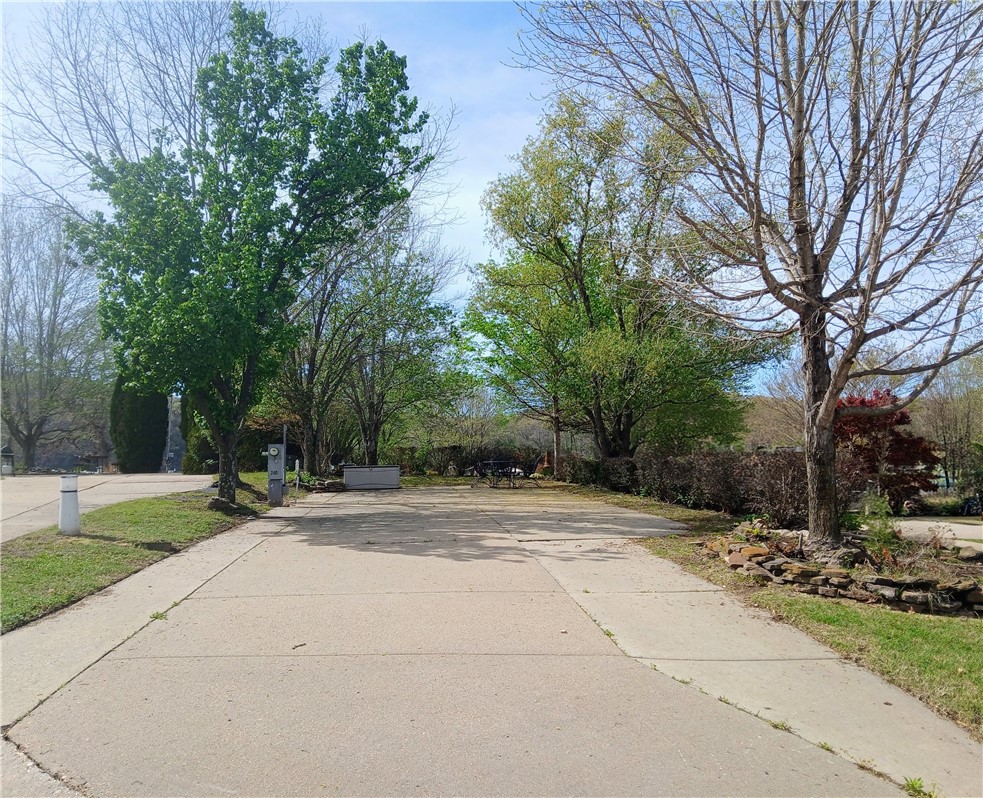 Experience upscale RV living at its finest with this premium luxury resort lot, perfectly designed to accommodate a 40-foot motor coach. Situated on a desirable corner location, this property offers simple landscaping, easy access, and mature shade trees. Enjoy serene water views of Table Rock Lake right from your site—an ideal backdrop for morning coffee or evening sunsets. Whether you're seeking a seasonal getaway or a long-term luxury RV destination, this property combines comfort, beauty, and convenience in one exceptional package. Take a break from the hustle of everyday life, the lake is calling!
