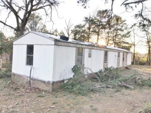 Brick foundation, new 50 gallon electric hot water tank, new sewer pipe under house.  Has tree damage to roof, for $2,000 owner will lathe 1x4 corrigated metal sheet iron over, 20'x20' metal shop with concrete floor