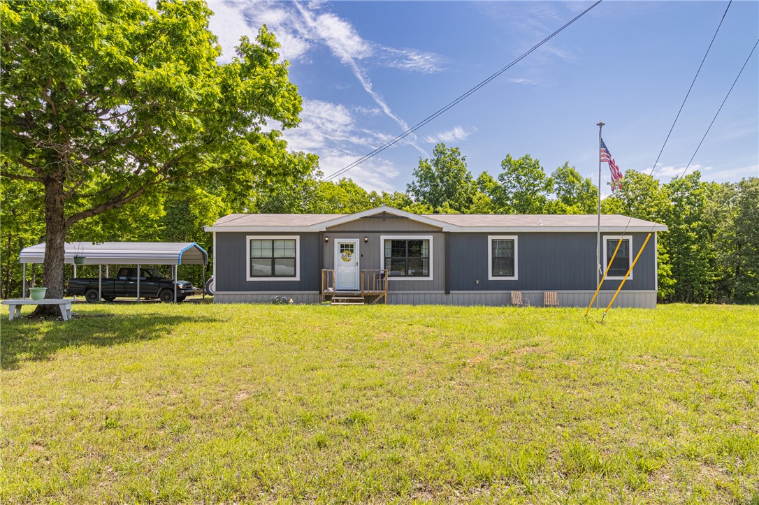 Five acres of Ozarks quiet, a 2022 Clayton manufactured home on a permanent foundation, and everything you need to settle in from day one. That's what 915 Mc 5004 delivers near Yellville, AR, in the heart of Marion County with the Buffalo River, Bull Shoals Lake, White River, and the best outdoor recreation North Central Arkansas has to offer just down the road. The 1,680-square-foot open floor plan gives you three beds, two full baths, and a layout that flows the way you actually live. Full skirting and underpinning, central heat and air, and a deck made for morning coffee. The five acres run part cleared, part wooded, level enough to use, and private enough to breathe. No restrictions. No HOA. What conveys seals the deal: a generator, all of the appliances, two TVs, outdoor table and chairs, and a walk-behind weed-eater. Move in and get after it.
