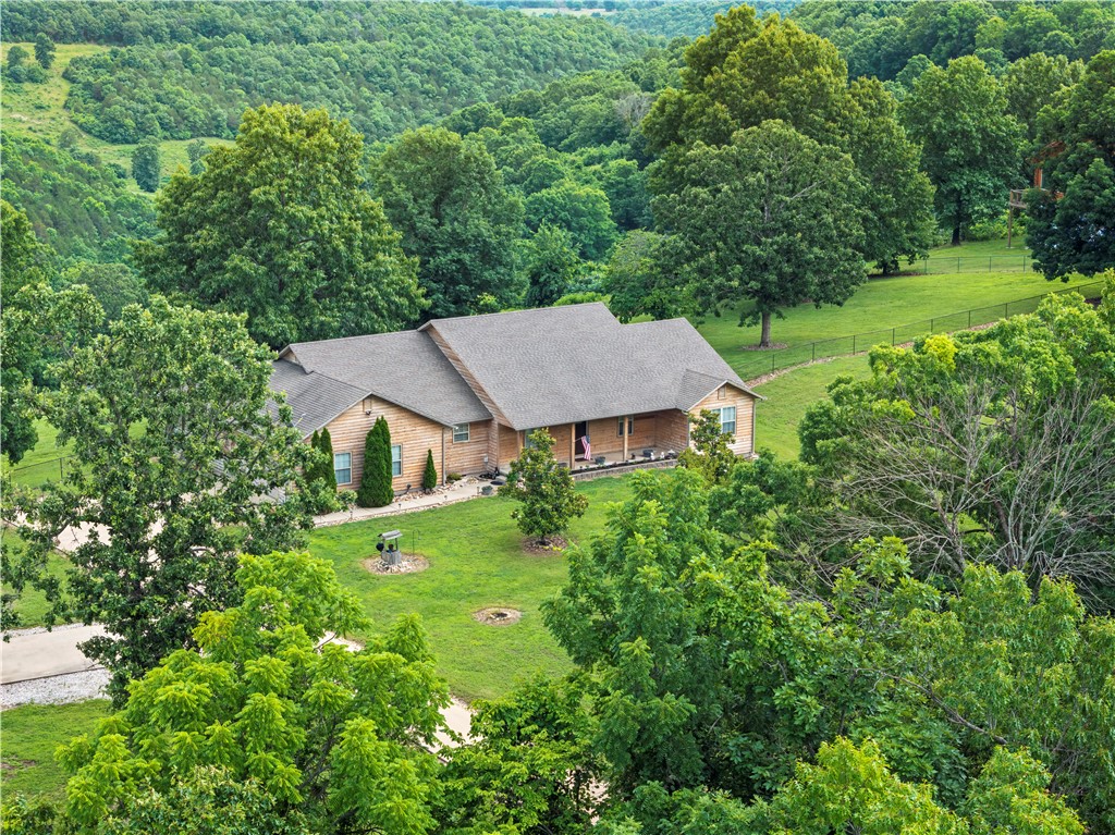 Enjoy breathtaking mountain and valley views from this 3-bedroom, 2.5-bath home situated on 3 acres between Harrison and Omaha in the Harrison School District. Offering the perfect balance of privacy and convenience, the property is accessed by only 0.6 miles of dirt road and is just a short drive to Harrison, Branson, and area attractions. Inside, the desirable split floor plan includes a spacious primary bedroom with illuminated crown molding, a sunroom, and a well-appointed kitchen featuring granite countertops and a dual-fuel range with a gas cooktop and electric oven. Step outside to the large covered porch, perfectly positioned to enjoy the spectacular scenery year-round. A 30x40 shop offers excellent space for storage, hobbies, or equipment, and RV electrical hookups provide added convenience. A rare blend of views, comfort, and functionality awaits.