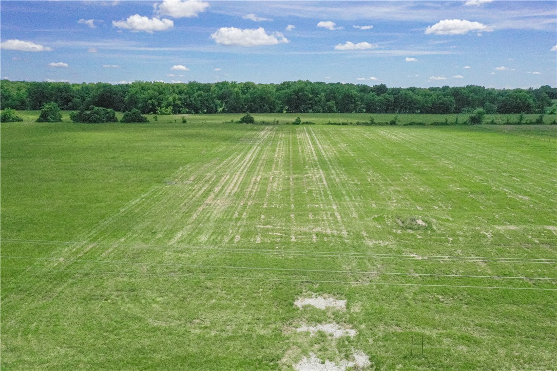 Here’s your chance to create a little breathing room in western Benton County. This 4.85 acre tract on Hwy 102 offers the kind of setting buyers keep searching for: space, flexibility, and room to imagine what comes next. Build your future home, create a peaceful country retreat, or invest in land near Gravette with easy highway access and an open, rural feel. With approximately 318 feet along Hwy 102, the property offers a practical layout for a future home, shop, garden, animals, or simply extra space to spread out and enjoy. Approximately 10 miles from the Oklahoma line, 9 miles from Decatur, 10 miles from Gravette, 14 miles from Gentry, and 16 miles from Siloam Springs. Buyer to verify utilities, zoning, build requirements, and intended use. Also available: 5/21/25 Perc test. 1/5/26 Soil test.  5/13/25 Survey.