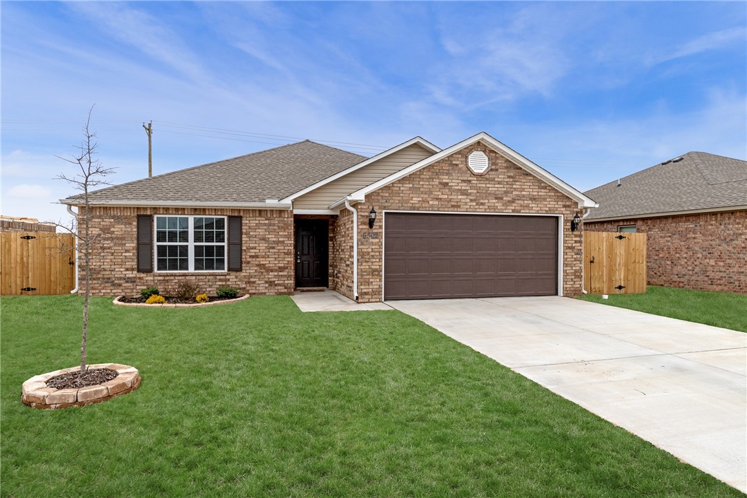 Beautiful brick home located in Bentonville! Large kitchen with granite countertops opens into the living room. Rich wood cabinetry throughout. Covered patio area overlooks spacious flat lawn with fence.