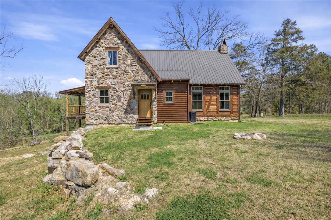 This is your chance to own a piece of the stunning Kings River. This luxury cabin offers the perfect blend of rustic charm and modern comfort, featuring a beautiful stone and wood exterior, vaulted ceilings, exposed beams, soft pine hardwood floors, and a striking floor-to-ceiling stone fireplace. Cedar log accents sourced directly from the property add a unique, natural touch throughout. The home also includes a whole-home Aquasure water filtration system.

The open layout is filled with natural light and designed for both relaxing and entertaining. Enjoy private river access, a community sandbar, peaceful wooded surroundings, and outdoor living spaces ideal for taking in the scenery. Perfect as a full-time residence, weekend retreat, or summer getaway.

Open House April 26, 12pm - 2pm.