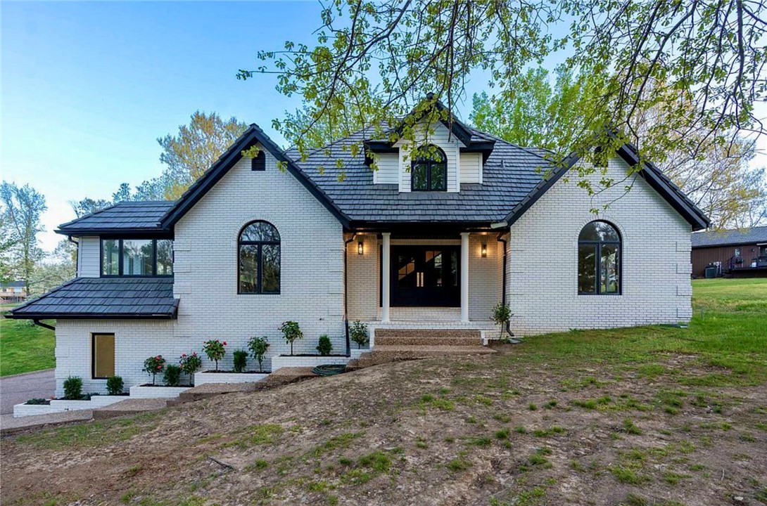 Welcome home to this immaculate Rogers Lake home with a community slip on Beaver Lake AND located close to town in Rogers! This home has been completely remodeled with every room updated. Property has a seasonal lake view and large driveway for extra parking. 3 levels of lake living offer 3 bedrooms and 2 additional flex rooms in the basement that have closets for extra living rooms. Property has 2 living rooms that open up to the kitchen serving as a grand entertaining space. Large multi-level TREX deck with a fully fenced in giant backyard. Main floor primary ensuite with large walk-in tiled shower and large closet. Custom Kitchen with new countertops, appliances and pantry by the main floor laundry room. Kitchen offers a central location for both living areas. 3 Car garage with extra storage. DaVinci composite roof will last a lifetime and new white oak flooring for easy maintenance throughout the main floor. Boat lift included with community slip located just seconds away. Far too many updates to mention!