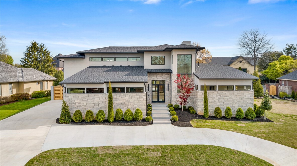 Luxurious new construction home, where unparalleled craftsmanship meets flawless design. This stunning 5-bed, 5.5-bath residence boasts a spacious 5,381 sf of sophisticated living spaces, designed to cater to the most discerning tastes. Step inside to discover the breathtaking open layout, impeccable wood flooring & walls of glass that provide an infusion of natural light & inviting ambiance. The chef's kitchen is equipped with top-of-the-line appliances, waterfall edge island, custom cabinets & adjacent butler's pantry that maximize both style & functionality. This home is filled with thoughtful amenities that elevate everyday living: sunroom for year-round enjoyment, spacious bonus room, 2nd kitchen that’s perfect for hosting, home generator & storm shelter. The expansive patio area with grilling station offers ample space for al fresco dining and lounging. Enveloped by the residence, the saltwater pool with water feature becomes an integral part of the architectural canvas providing an aura of peace and privacy.