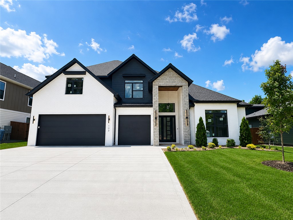Located in the perfect location w/ easy access to Coler Mountain Bike Preserve trails, schools, downtown Bentonville & more. The heart of this haven is undoubtedly the chef's kitchen, sprawling island, vegetable sink, 5-burner/double oven gas range, quartz counters, walk in pantry, and custom stained exposed beams. Living room centers around stunning tile gas fireplace, enveloped by oversized windows that bathe the space in light and soring 2 story ceiling with track lighting. Retreat to the primary suite, where oversized windows invite in sunlight & spa-inspired bath with a walk-in tile shower featuring double showerheads, soaking tub, double sinks, smart mirrors & walk-in closet with pull down rods. Secondary bedroom on the main level with wood floors, custom beams and accent wall would also be the perfect study. Upstairs reveals a generous bonus room with a wet bar and three secondary bedrooms. Enjoy the oversized covered patio overlooking the fenced backyard. $3,000 if you use the preferred Lenders
