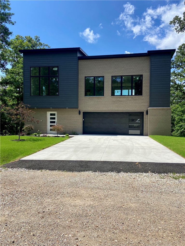 Surrounded by trees, this unique home offers a true “treehouse” feel with beautiful wooded views from expansive windows and abundant natural light. The open-concept main level features a spacious living area, oversized island, custom cabinetry, and a hidden/butler’s pantry—perfect for entertaining. The primary suite is a private retreat with serene views of the woods. The upper level includes the primary suite, kitchen, living area, and half bath, while the lower level offers two bedrooms connected by a Jack-and-Jill bathroom and a versatile flex space. Enjoy an oversized patio and a deck overlooking the woods, with no homes directly behind for added privacy. Located near the mountain biking trails and amenities that make Bella Vista so desirable, this one-of-a-kind home truly stands out.