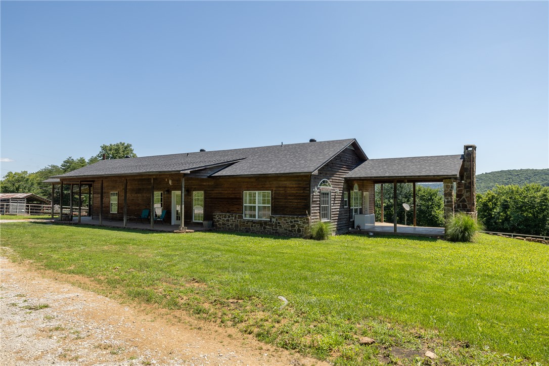 Escape to 129.53 acres of quintessential Ozark Mountain beauty! Perched on a bench above a picturesque valley, this 2BR/2.5BA 1920 sqft home offers sweeping mountain views from a wraparound porch—relax and watch bear, deer, turkey, and the occasional wild hog roam the property. Minutes from Ozark National Forest, 25 min to Elkins, 40 to downtown Fayetteville, this farm or recreational retreat delivers true seclusion with miles of backroads perfect for side-by-sides or gravel bikes. Outbuildings galore: 42x50 metal shop with concrete floor and electric freezer does not convey, 55x35 hay barn, 55x42 barn, and 30x25 garage offer storage, workspace, or livestock potential. Rural water and an owned 500-gal propane tank add convenience. Whether managing wildlife, building a working farm, or craving Ozark serenity, this property checks every box. Come experience peace, privacy, and panoramic views—your Ozark sanctuary awaits! Also listed as a residential listing mls#1352627