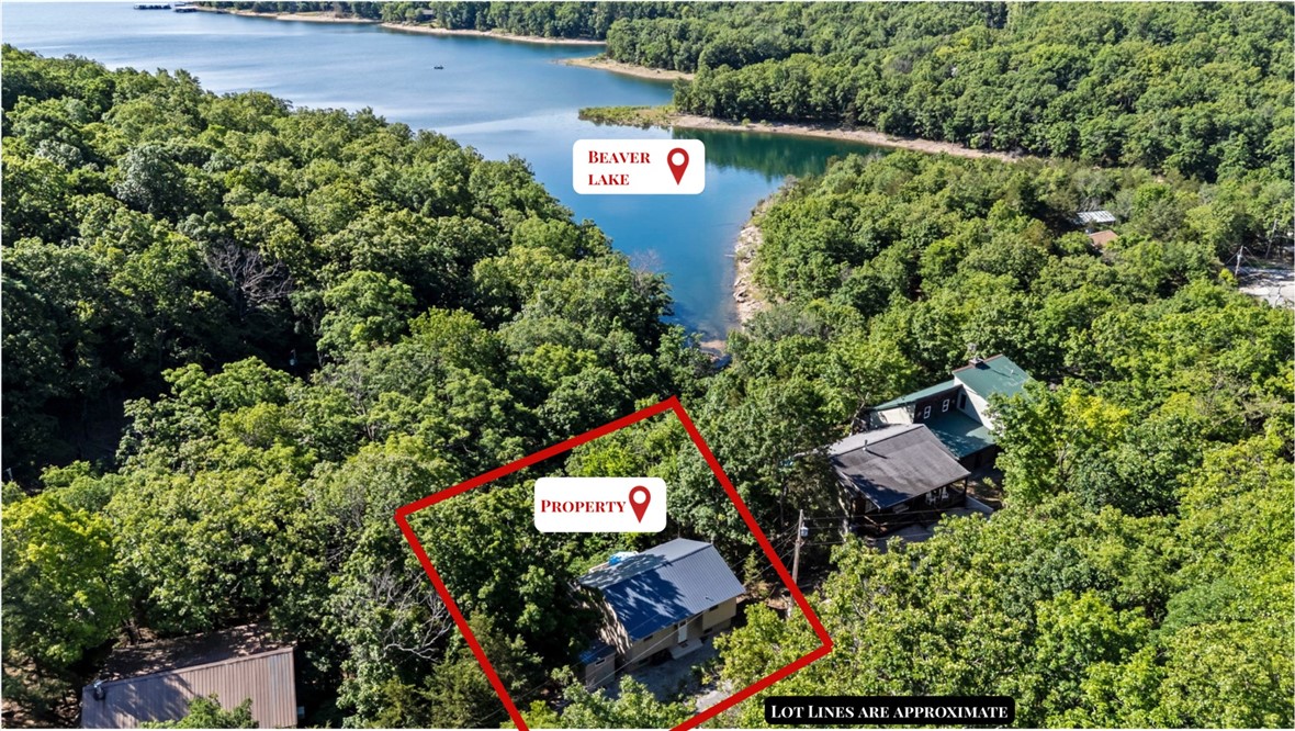 Say hello to Beaver Lake Living with direct access to the water! Nestled in the woods on Beaver Lake, this charming cabin in Lost Bridge Village is the perfect lake retreat. Surrounded by mature trees, the property features two spacious decks & an 8x7 storage shed for lake toys & tools. Inside, you’ll find an inviting two-level layout with an open-concept living area, a nicely appointed kitchen, two bedrooms, & two full baths. The lower-level family room provides additional flexible living space & could serve as a third sleeping area or bunk room. Recent updates include a new dishwasher, sump pump, & water heater in 2022, plus a new microwave & refrigerator in 2023. Brand-new this month are the roof & HVAC system, with new guttering scheduled to be installed ASAP. Whether you’re searching for a weekend getaway, vacation rental opportunity, or your own Beaver Lake home, this property checks all. Lost Bridge Village amenities include swimming pool, airstrip, tennis courts, library, & rec hall.