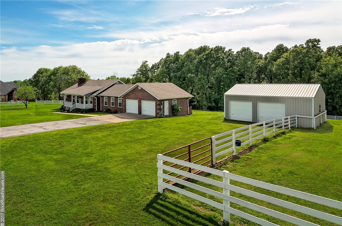 Four +/- acres with out buildings including 840 sq. ft. barn & potting shed that could be used as playhouse. Property line is partially fenced w/small backyard and pasture completely fenced. Enjoy deer and hummingbirds from your back deck. Home is open, split floor plan w/new paint, approximately 1 year old wood floors, new tile in bathrooms, new dishwasher & garbage disposal.  Amenities include gas tankless water heater.  Electricity at home ready to run to barn w/garage doors. Electrical for hot tub.