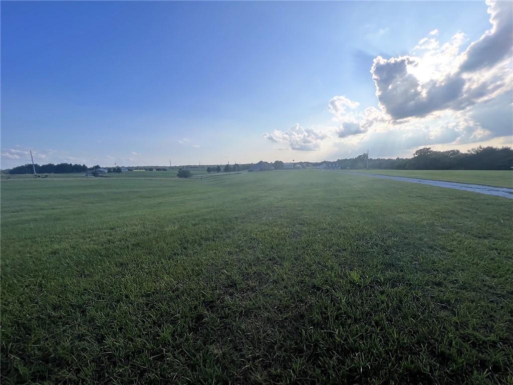 Are you looking for a beautiful piece of land to build your dream home? Are you a builder looking to develop this acerage for 2-3 executive homes? Look no further as this pristine property is what you are looking for! 3+/- beautiful acres in Har-Ber School District. Lot is already split to 3 acres. Build your dream estate on all three acres or build 2-3 custom specs for investment to sell. No matter what your dream home is, you can make it happen on this land! If you are a builder looking for lots, you can build two to three custom homes on this property (1 home per acre) or build one really nice home. The opportunity you have been waiting for. Sellers will require an easement of existing driveway upon approved contract.