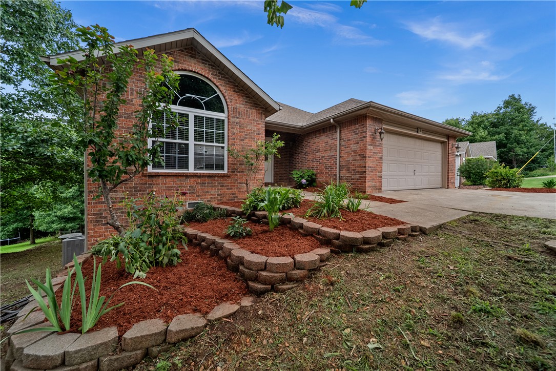 Welcome home to this beautifully updated 5-bedroom, 4-bath residence located in the highly sought-after Bentonville School District! This spacious home has been thoughtfully refreshed with brand-new flooring throughout, fresh interior paint, stylish new light fixtures, and a brand-new stove/oven, making it truly move-in ready. The desirable split floor plan offers both privacy and functionality, while the fully finished lower level features an additional living area, three bedrooms, and two full bathrooms—perfect for guests, multi-generational living, or a growing family. Situated on a paved road with the peaceful charm of country living, you'll enjoy stunning wooded views from both back patios, creating the perfect setting to relax, entertain, or simply enjoy the beauty of nature. This home offers the ideal combination of modern updates, generous living space, and a serene setting you won't want to miss!