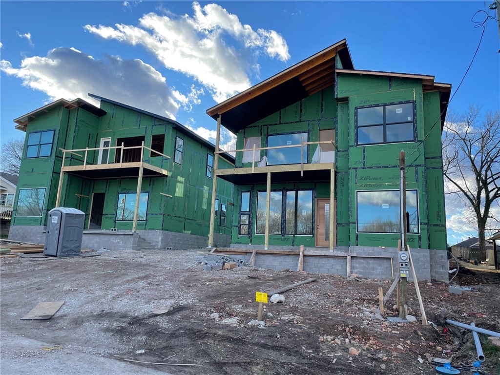Look out your front door and see the mountain bike trails from this modern new construction home in downtown Bentonville. Peek-A-Boo, Boo Boo & Patti-Cake trail are located right across the street connecting you into Slaughter-Pen and over 80 miles of mountain bike trail or if you are looking to get on the greenway, the trail head on NE A ST is a short walk and you can access the Crystal Bridges Overlook. The Briartown area is exploding with new development. 
This home features modern details from its sloped room design to its cantilevered island and spa like bath. The kitchen is amazing featuring GE Cafe Series appliance including a 36" industrial range along with a 72" built in fridge and a huge pantry with wine storage. The open main living area features 12' ceilings. The owners suite is also on the main level and features 10' ceilings and one of the most amazing showers you have ever seen. Upstairs are 3 large bdrms, a family room, laundry area and an upper deck. The yard is fence plus a 3 car garage.