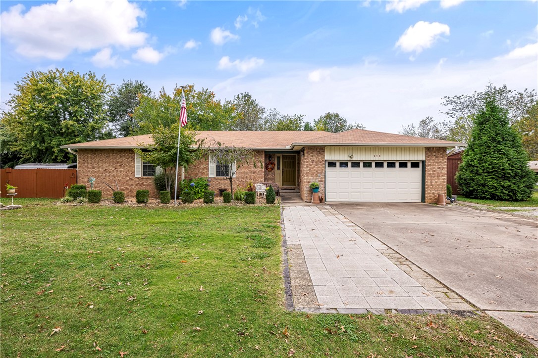 Charming Brick Home on a 1.33 Acre Corner Lot in Lowell! Discover this unique and well-maintained older brick home just on the brinks of South Rogers, offering ample space and potential. This property features spacious room, a cozy wood-burning stove, and a convenient W/I pantry. Enjoy a brand-new HVAC system, newer roof, gutters and windows. Outdoor amenities include RV pad complete w/septic hookup & electric, a covered deck and a large patio perfect for entertaining! The property also boasts a workshop w/roll-up door & electric, three carports & an oversized two-car garage, alongside a 32 x 12 Derksen barn for additional storage or workspace. With potential for future rezoning to C2- this property is ideally located near restaurants, shopping, I49, the Razorback Greenway Trail, hospitals and schools. So many opportunities to make this property your own! Don't miss your change to own this exceptional home in a fantastic location!