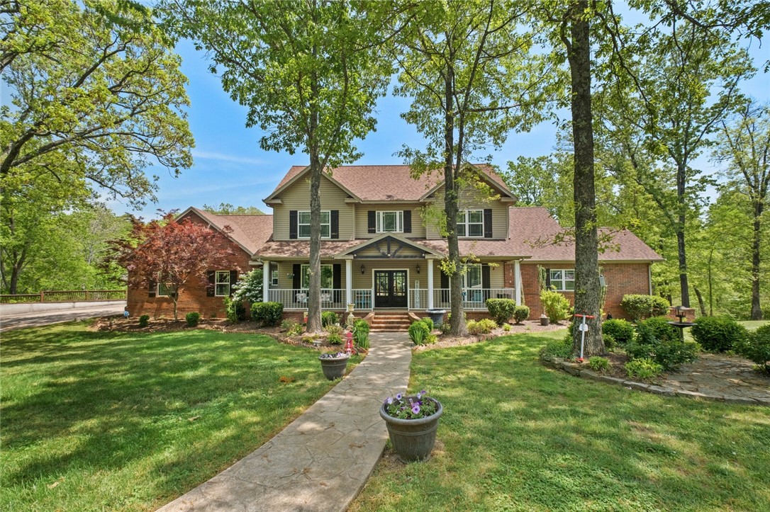 Priced Below Appraisal value. HOBBY FARM/Huge SHOP perfect for a business 13+ Acre Estate ideal location 5 min from New Walmart campus & I-49. Beautiful winding paved drive with lighted lamps leading to an abundance of parking beside this gorgeous 4100 + HSF Craftsman style home. Oversized cooled 4000 (80x50) SF shop w 4 bays & overhead doors which could transformed in to any business or ultimate space. 36x36 Pool house and garage with in-law apartment built in.  Inground Salt water pool, plenty of fenced acreage for any animals your heart desires. This Tri-level dream home with natural light featured in the great room, perfect to gaze out over a luscious landscape of wildlife and nature. Large master suite with separate/dual  vanities, large walk in closet, Whirlpool, walk in shower. Downstairs walk out basement gives a touch of country with the Rustic wood trimmings, full wet bar, large second Living area, 2 bedrooms, full bath, and outdoor access. Unlimited possibilities to make your dream become a reality.