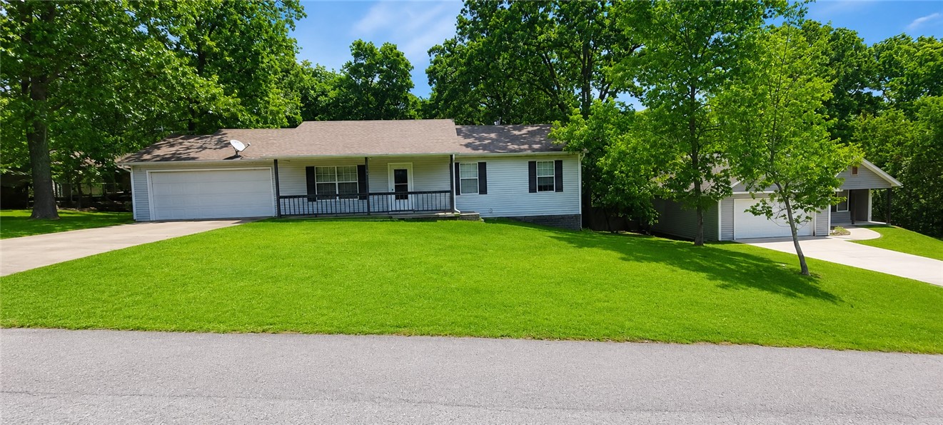 Great opportunity to update and make this home your own—whether as a primary residence, second home, or investment property. 3 bedroom and 2 bath single-level home offers just under 1,400 sq. ft. with a flat front yard and gentle backyard slope. The back deck creates a great outdoor space to enjoy. Conveniently located just 1.9 miles from Hwy 71 via Trafalgar for easy access in all directions. Major updates include HVAC replaced 7 years ago and water heater 4 years ago. Septic pumped 5-13-26, HVAC inspected 5-14-26, New carpet installed in living room 5-21-26. Inside, the spacious living room with high ceilings flows nicely into the kitchen and dining area. Enjoy Bella Vista amenities including 7 golf courses, 7 lakes, tennis, pickle ball, clubhouses, hiking and mountain biking trails, plus the future chair lift at OZ Trails Bike Park less than 4 miles away. Conveniently located near back 40.