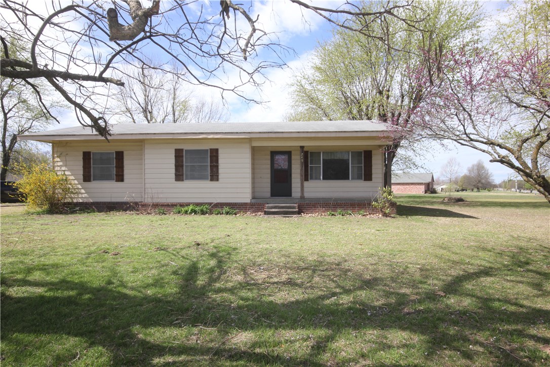 Back on the market. Looking for some elbow room? This 3 bedroom home sits on a 1.08 acre level lot.  Minutes to I-49.  Country living with city convenience.  Kitchen features ceramic tile counters and backsplash. Dining area has a built-in hutch. Detached garage with storage room/workshop. Large utility room.  Nice concrete circle drive perfect for accommodating guests. Near planned future Sports Park. Don't miss seeing this home.