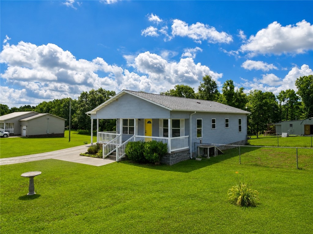 Charming 2-bedroom home with rental potential!!
This inviting 2-bedroom, 1.5 bath home offers comfort, updates, and excellent value. Enjoy relaxing on the covered front porch, while the fenced area provides a safe space for pets or children's play area.  Inside, you'll find new vinyl plank flooring and a beautifully remodeled kitchen featuring new cabinets, granite countertops, and stainless-steel appliances. The water heater was replaced recently. With all the updates and all appliances conveying, this home is move-in-ready. Outside, a nice storage building offers additional space for tools, equipment, or storage. The property also includes a smaller mobile home that, with a little work, could provide excellent rental opportunity, guest quarters, or extra storage.
Whether you're looking for a primary residence or an investment with added income potential, this property is one you don't want to miss!