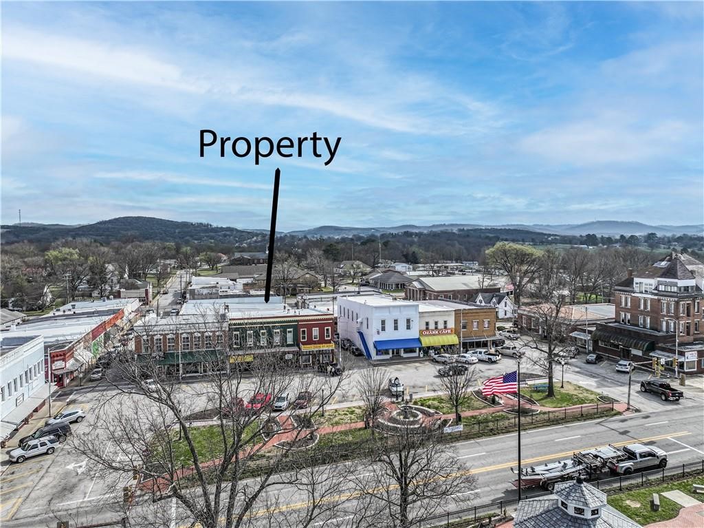 Prime Investment Opportunity in Downtown Berryville. Step into a rare chance to own a piece of Berryville history with this beautifully restored 1920s commercial building located on the vibrant town square. Just off Hwy 62 with high daily traffic count. Whether you're an investor seeking steady income or an entrepreneur ready to run your own pub, this property offers unmatched versatility and charm.  Main Level: Poncho Goldstein’s Irish Pub – Fully remodeled and ready to go. Large Attorney’s Office – Professional tenant in place. Upper Level: 4 Rental Apartments – 3 currently leased; 1 under renovation (finish to your taste) Additional Unit: Retail Space + 1200 sq. ft. Living Quarters – Previously an art and teaching studio; ideal for boutique, gallery, or creative workspace. Flexible Use – Ideal for retail, hospitality, office, or mixed-use.  This is more than a property, it's a gateway to community, creativity, and cash flow. Ready to explore the possibilities? Let’s set up your private showing today.