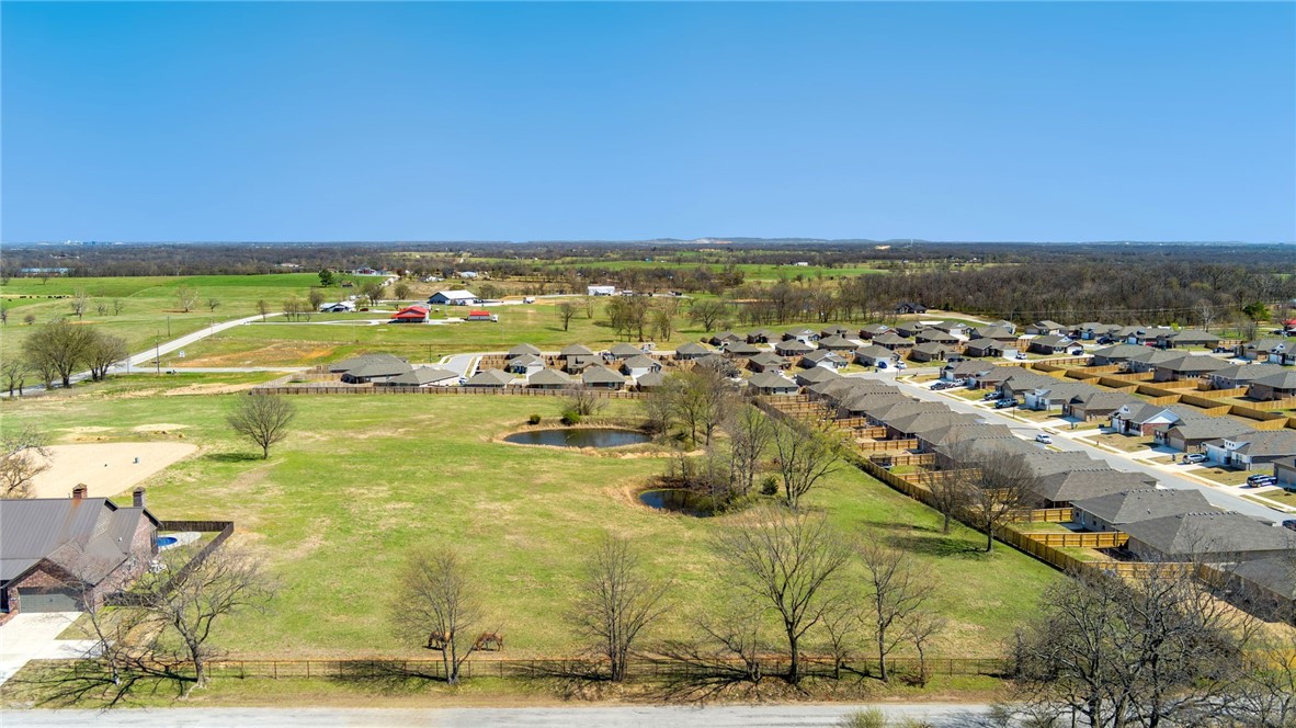 Rare find: Spectacular, level 5-acre parcel situated near XNA and in the growing city of Highfill. Easy access to Hwy 112 and I-49. This spot is an ideal place to build your forever-home, where you can enjoy seeing the stars and breathing in the fresh air. The property includes two spring-fed ponds—one is even stocked for hours of fishing and recreation enjoyment. Perfect situation for hobby farm or homestead. Electric, gas and water available. No mobiles allowed.  Larger tract was recently surveyed and split.  Don’t miss your chance to make the country life your life!