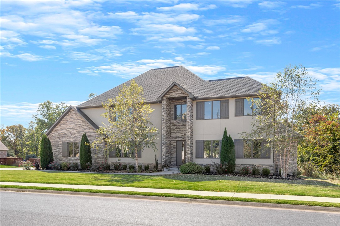 Modern, Luxury, Estate nestled on 1.48 acres with a very private, serene, wooded view in one of NWA’s premier neighborhoods, Estates of Oak Tree. This 5 bdrm home, all en-suites, w/ a 2nd bdrm on main level, also boasts an open kitchen, living room, dining room, all perfect for entertaining, as well as, a bar/media room w/garage door that opens up to pool/hot tub & covered patio complete w/double-sided fireplace & built-in grill perfect for relaxing after working all day in the home office. Wanting to escape? Retreat to the very, private master suite/bath, upstairs to one of the 3 spare bdrms plus bonus or burn it off in the home gym. This is one home that has it all…you never have to leave!