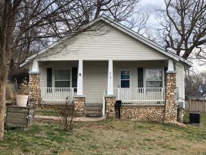 Charming 2 or 3 BR home was updated in 2013 with newer windows, roof, siding & CH&A.  Features include a remodeled kitchen and bath, hardwood floors, bay window with bench seat, gas log fireplace, covered porch and deck, large storage shed, metal carport. Mature shrubs and trees. You really need to check out this vintage home!