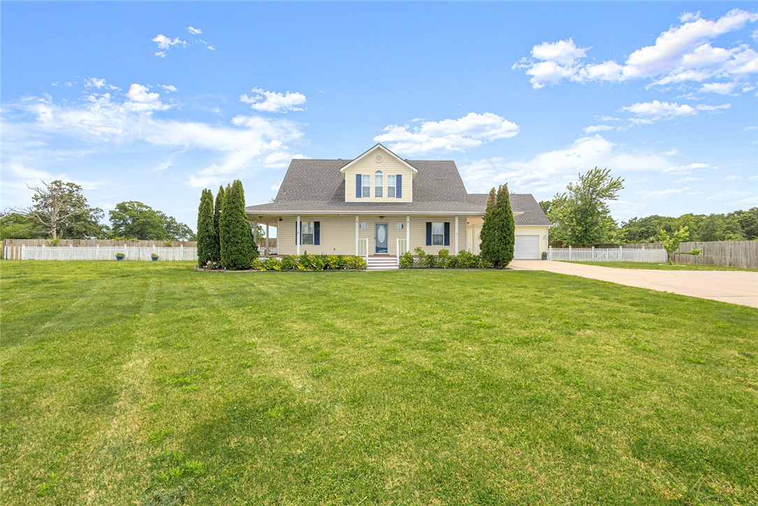 Welcome to this charming farmhouse-style retreat nestled on 1.13 acres in sought-after Bentonville! This beautifully maintained 3-bedroom, 2.5-bath home offers the perfect blend of country charm and modern comfort. From the inviting wrap-around porch and white picket fence to the warm interior finishes and abundant natural light, every detail feels like home. The spacious layout features a formal dining room, media room, stainless steel appliances, and a cozy pellet stove for added character. Step outside to your own backyard oasis complete with an in-ground saltwater pool, fire pit area, outdoor bar with built-in TV, and plenty of room to entertain, garden, or simply enjoy the peaceful setting. Attached 2-car garage plus a detached 30x30 garage/workshop provides endless possibilities for storage, hobbies, or extra parking. Enjoy quiet living with convenient access to Bentonville amenities, schools, and the airport. This one truly has it all!