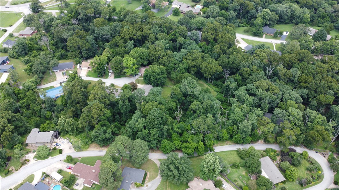 Opportunity to own a rare .64 acres Residential Lot near Downtown Rogers & Lake Atalanta! There aren't many vacant lots left to build a new home in an established neighborhood, only one mile from the Downtown amenities, parks & schools. Located on a quiet street surrounded by mature trees & nature, the street frontage runs 245' from power pole to power pole with water, gas & electric utilities all there, along with a recent survey & past perc 2022. This site is ready to go!