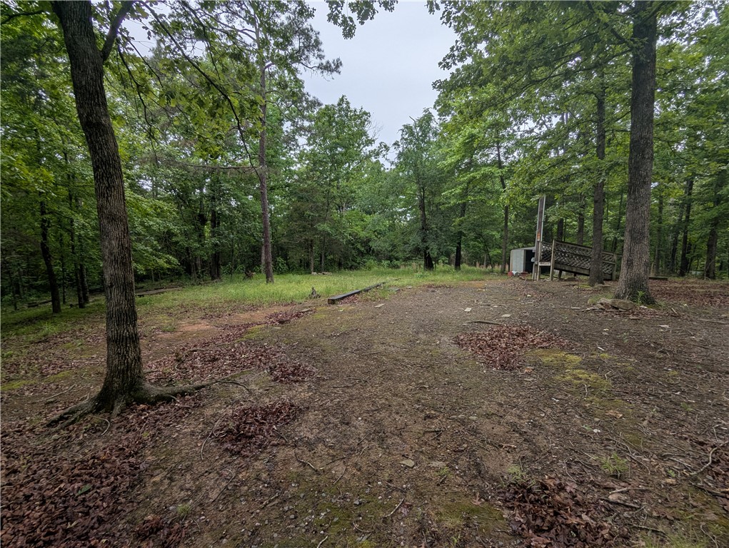 This property was used for a vacation spot developed for RV and Camper. 50 amp electrical service on site along with RV connection to septic sewer and county water.  1/4 to 1/2 acre spot large enough to turn camper around and park.  Quite neighborhood, shaded and some wet weather creeks on the lot.