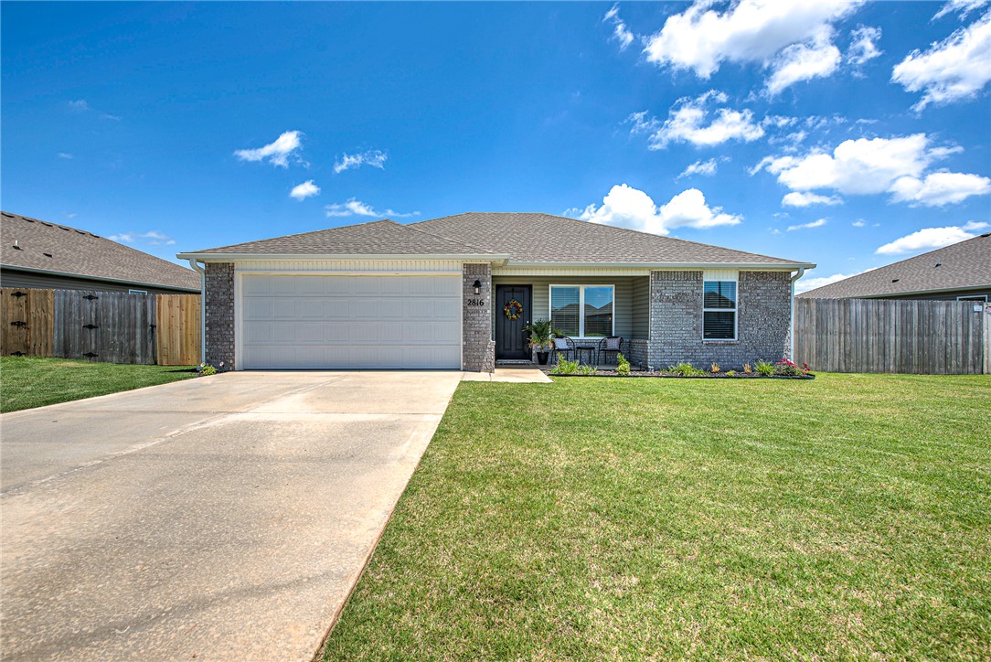 Warm, welcoming, and truly move-in ready, this one-year-old home offers a thoughtful blend of comfort, functionality, and everyday livability. Designed with a split floorplan, the layout creates a sense of privacy while still offering open, connected living spaces that feel inviting and easy to enjoy. The bright kitchen and living area flow naturally together, making the heart of the home perfect for both relaxing evenings and gathering with friends and family. The primary suite is tucked away from the additional bedrooms in a layout buyers consistently love. Sitting on a spacious 0.21 acre lot, the fully fenced backyard offers plenty of room for pets, play, entertaining, gardening, or simply enjoying quiet evenings outdoors. An expanded concrete patio creates even more space to enjoy outdoor living, while added gutters provide additional functionality and peace of mind. Blinds, refrigerator, washer, and dryer all convey. Buyers can also enjoy the remaining builders warranty and a $2,000 preferred lender credit.