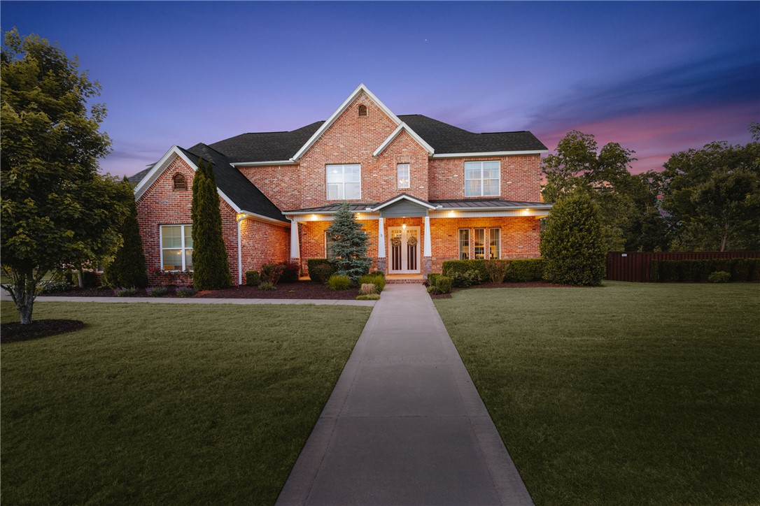 Set on 1.98 acres in Oak Tree Estates, this stunning home offers luxury living with resort-style amenities and an ideal layout. Featuring 5 bedrooms with direct bath access, a home office, bonus room, media room with wet bar, and spacious open living areas filled with natural light and wooded views. The chef’s kitchen includes a large island, KitchenAid appliances, built-in refrigerator, 6-burner gas cooktop, espresso machine, and oversized pantry. The primary suite is a true retreat with vaulted beamed ceilings, fireplace, spa-like bath, and custom walk-in closet connected to the laundry room. 2nd Level features 2 guest beds w/en suites & another 2 beds sharing jack & jill bath. Bonus room with half bath and attached media room w/wet bar. Outdoors, enjoy a spectacular pool with slide, hot tub covered patio with fireplace and built-in grill, multiple entertaining spaces, iron fencing, and expansive yard space. Located in a sought-after community with easy access to Downtown Bentonville and I-49.