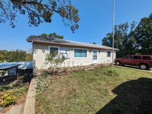 It's hard to get close to the lake yet stay affordable but here it is with this 3 BR home just blocks from Bull Shoals Lake, right down the road from the Marina with fenced back yard, large pantry, workshop area in basement, fenced backyard, storage shed, covered patio and detached carport.  All #s are approx., age & square footage per assessor.