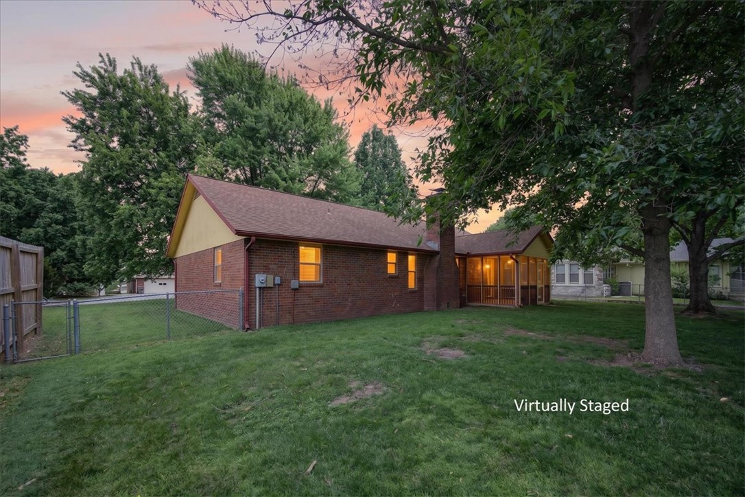 A backyard big enough to leave the bad days behind. New construction simply can’t compete with this 0.63-acre lot. Located in the heart of Lowell, you'll find a lot filled with mature trees, green grass, and endless possibilities.  Whether you’re unwinding on the screened-in back porch, enjoying evenings by your firepit, or tackling projects in the shed this property offers space to truly live. 

Inside, warm wood floors and a cozy fireplace make the living area feel inviting and comfortable — the kind of space that instantly feels like home. With an amazing location and quick access to I-49, you get the best of both worlds: convenience when you need it and a backyard retreat when you don’t.