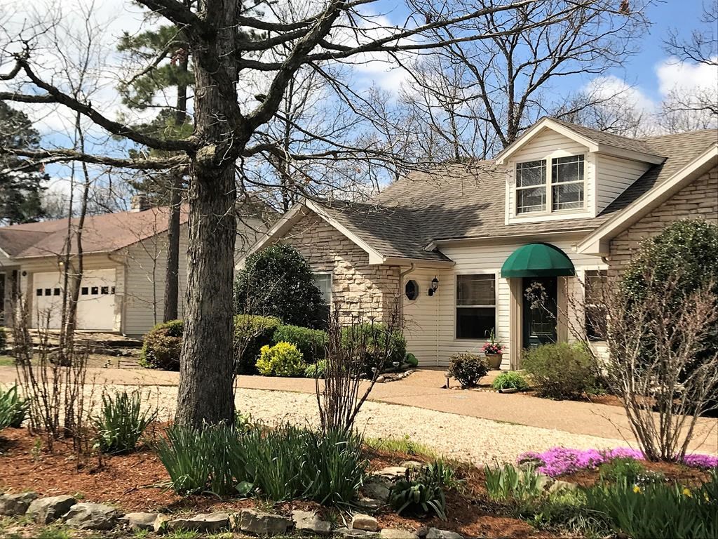 This beautiful home welcomes you with lovely landscaping and light bright rooms. Fine finishes, such as the stone fireplace, vaulted ceilings, hardwood floors and cottage-style kitchen cabinetry, accent every room. The split floor plan offers convenience and privacy. And the sunroom with a garden view is filled with warmth and charm. Step out to the deck to enjoy the birds and the gardens surrounded by the privacy of your own park-like woods. Home has been meticulously maintained & thoughtfully updated.