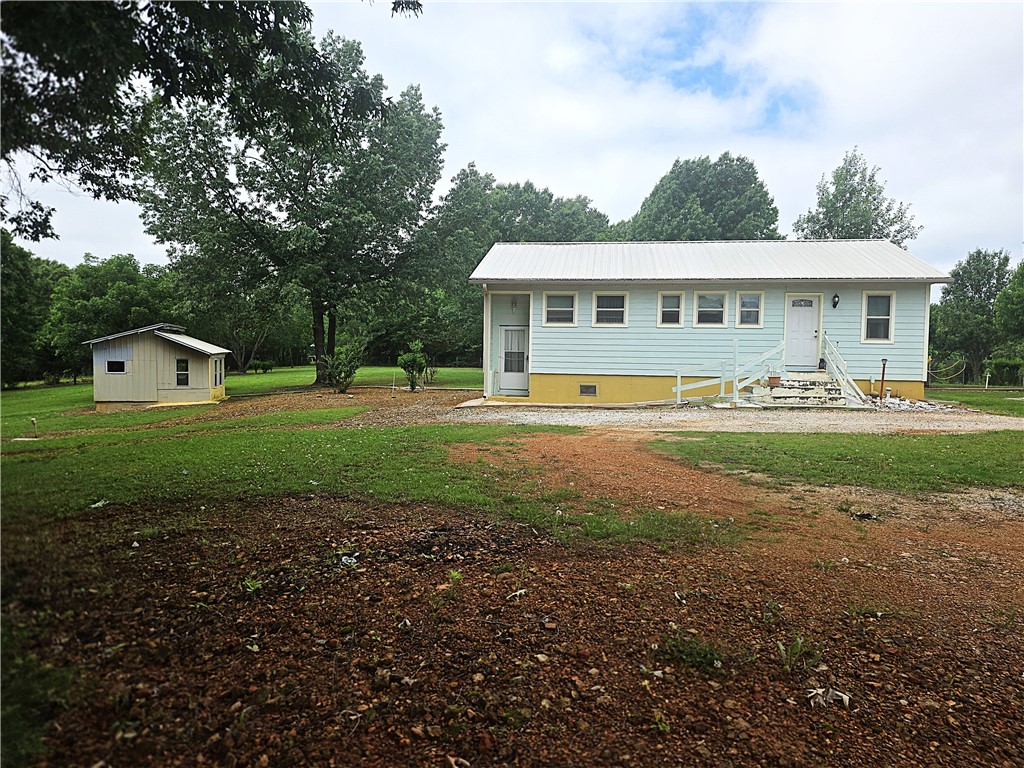 This home sits on a well manicured 2.24 acre yard on the North side of town having 2 bedrooms and 3 bathrooms. Home was built with a wide hallway and wide doorways to accommodate wheelchair. There is an option to have a 3rd small bedroom. The basement is immaculate providing a large amount of extra space to either finish out for living quarters or use as storage. An outbuilding provides even more storage plus this home comes with a generator! Don't miss taking a look at this one.