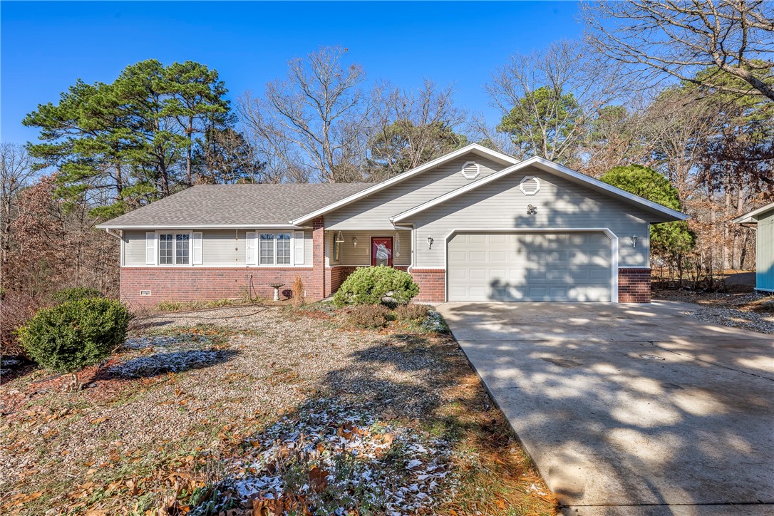 $3,000 – Preferred Lender Credit! Perfectly situated between Lake Ann and Lake Rayburn, this home offers the best of Ozark living. Outdoor enthusiasts will love being just minutes from the Back 40 Buckingham Trailhead, providing easy access to hiking, biking, and nature adventures. Step inside and be greeted by a wall of windows that frames a stunning view, filling the home with natural light and creating a warm, inviting atmosphere. The open layout is ideal for entertaining of relaxing, and the property is move-in ready for its next owner. *New roof Oct 2025. 1 Year Home Warranty!