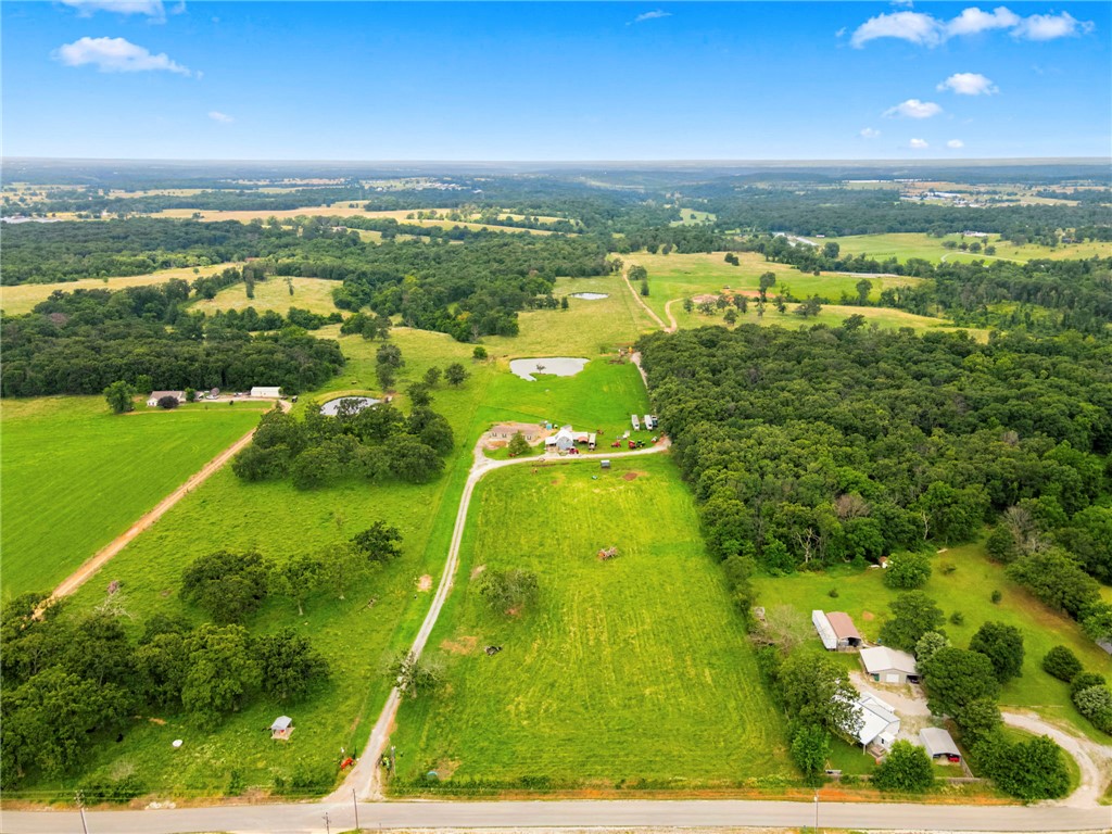 Prime opportunity to own approximately 100 acres in a rapidly growing area just minutes from town. W/ water available & sewer access at the street, this property offers outstanding potential for a variety of uses. Whether you're looking to establish a working farm, raise livestock, build your dream estate, or explore future development opportunities, this property provides the space and infrastructure to bring your vision to life. As the surrounding area continues to grow, this acreage presents a rare chance to secure a valuable long-term investment in a highly desirable location. A beautiful spring-fed creek meanders along the back of the property, creating a peaceful natural sanctuary with abundant wildlife and scenic views. The combination of open land, utility access, prime location, and natural beauty makes this a truly exceptional offering with endless possibilities.