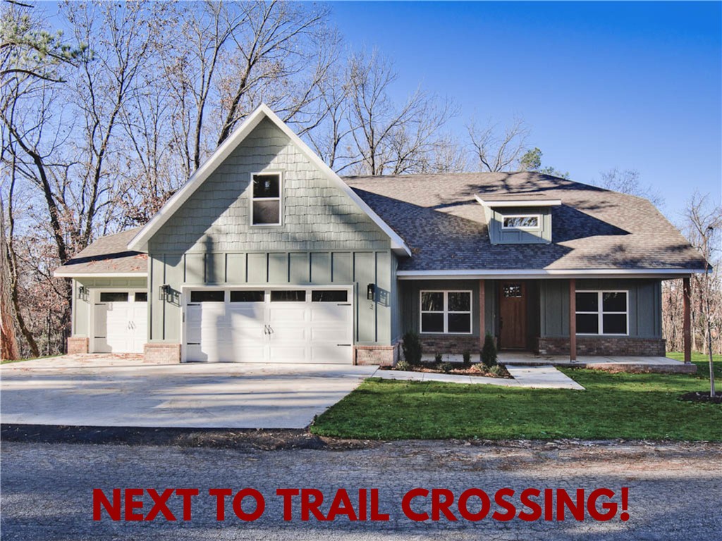 New construction on a large .34 acre wooded lot! Located next to the Flo Ride Crossing and just minutes to Lake Ann and Lake Brittany! WOOD FLOOR THROUGHOUT (NO CARPET!) Features include a spacious 3-car garage, 3 bedrooms + upstairs bonus room with full bath. The kitchen is equipped with a large island, 3 cm quartz counters, custom cabinets, and a gas range. The living room boasts a beautiful fireplace, exposed beams, and a stunning cathedral ceiling. The primary bath features a luxurious soaking tub, separate vanities, and a huge walk-in closet with a custom tile shower. Custom finishes throughout. Bentonville schools. Front exterior will be painted Sherman Williams Evergreen Fog. $3,500 in closing costs when using the builder's preferred local lender.