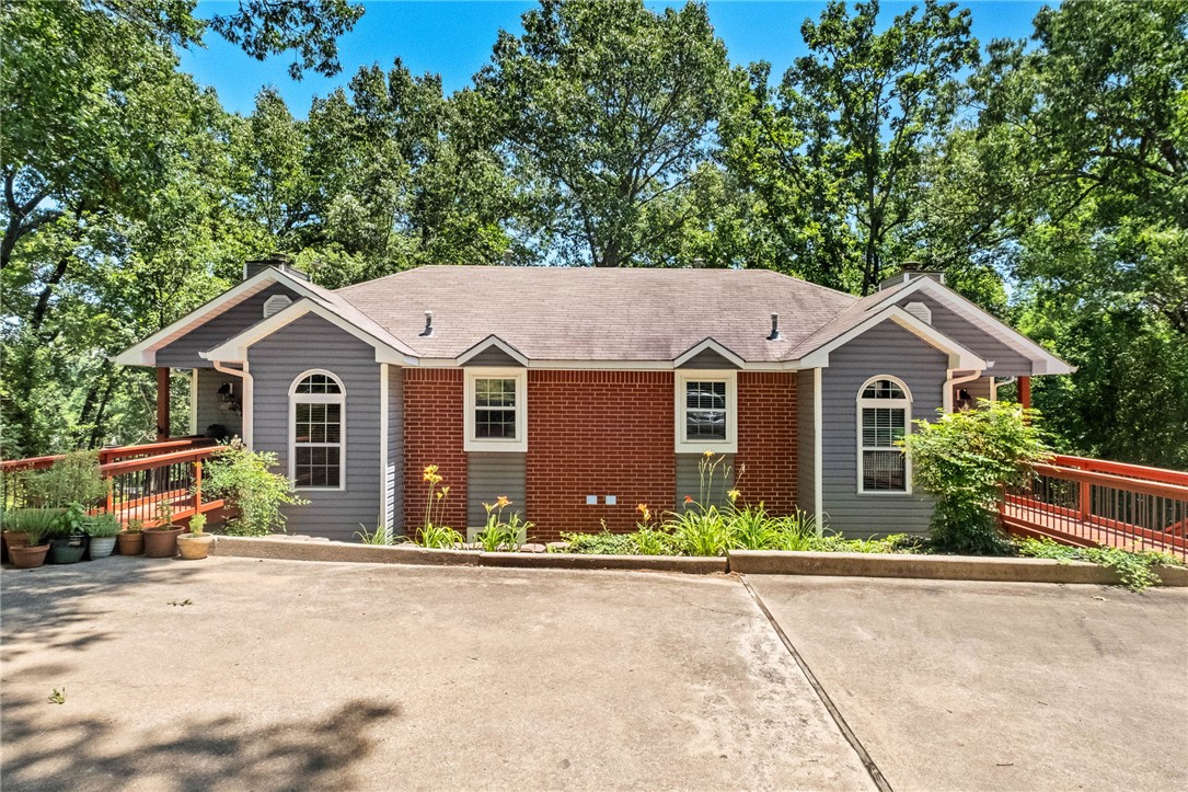 Unbeatable North Bentonville location near bike trails, dog park, and easy access to bypass.  This fabulous duplex with 3 bed 2 1/2 bath per side great for an income producing property.  Live in one side Airbnb the other.  Over an acre of property to give you the space for privacy in back for firepit and entertaining. You will love the peaceful decks watching birds and nature come to life. Main floor for all you living needs, complete with eat in kitchen, living with fireplace with blowers, utility and guest 1/2 bath, downstairs complete with 3 bedrooms 2 bath.  Owners have made several updates through the years.  Whether you are looking to increase your rental portfolio, house hack and utilize passive income, or your new way of life- this one is ready for you.