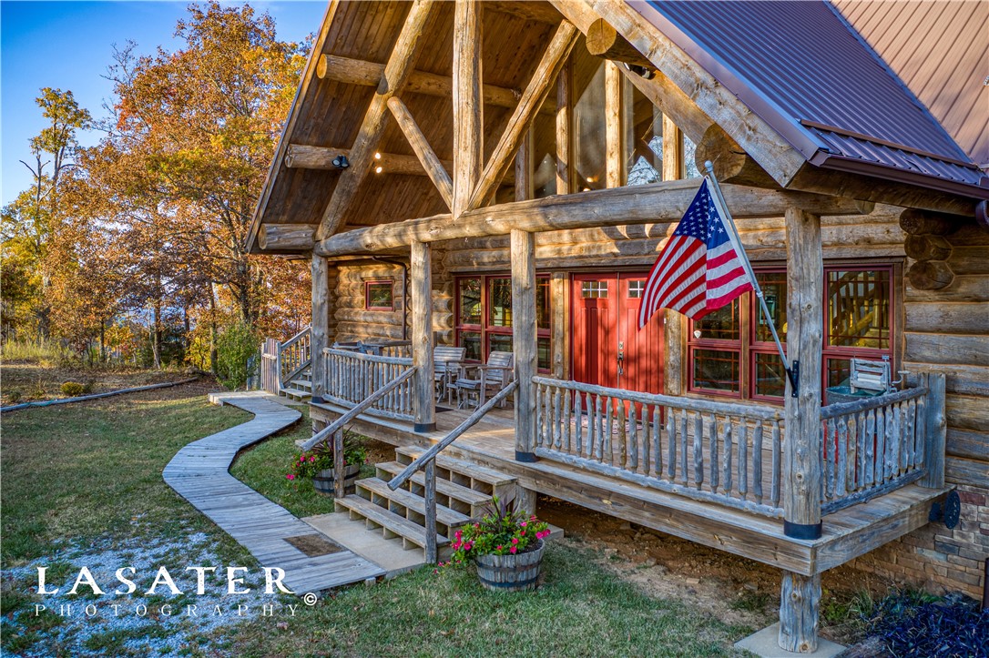 Custom large Montana log home & a million-dollar mountaintop view over Jasper & the Buffalo River Valley.  40-mile visibility to Branson.  Custom interior woodwork. 14.2 well-manicured acres.  Beautiful large spring fed stocked pond. Enter property thru pastureland past pond to home.  Enjoy backyard views from 3 deck levels with views and shooting range.  15 minutes from Buffalo National River and Johnny Morris upcoming Marble Falls Natural Village.  Large 2 car garage.  Elevator and handicap accessible.