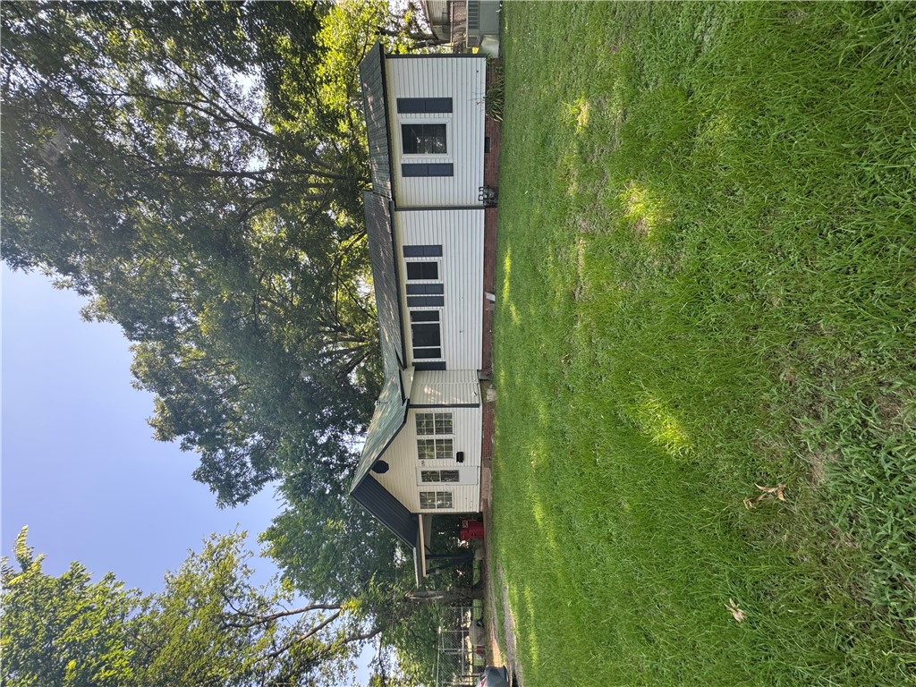 Nestled along the river with beautiful water views, this charming older 2-bedroom, 1-bath home is full of character and potential. Relax year-round in the spacious sunroom while taking in the peaceful scenery, or enjoy the large backyard with plenty of room for gardening, entertaining, or simply unwinding. The fenced front yard offers added privacy and a great space for kids or pets, while the attached carport provides everyday convenience. If you've been looking for affordable riverfront living with endless possibilities, this property is one you won't want to miss!