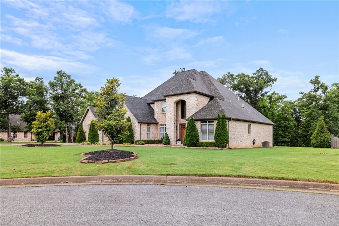 Experience the prestige of Versailles from this exceptional custom home situated on 1.84 private acres. Offering 4,966 square feet of living space, this home balances elegance, comfort, and versatility. The chef’s kitchen is the heart of the home, featuring two oversized islands, top-of-the-line appliances, abundant cabinetry, and ample space for entertaining. The open-concept layout flows into a cozy living room with a gas fireplace, while a second living area with its own gas fireplace provides additional space to relax and gather. The main level includes a luxurious primary suite and an en-suite guest bedroom.  Upstairs, you'll find a spacious lounge opening to a private patio and a media/flex room offers endless possibilities to suit your needs.  Enjoy luxury living on a quiet cul-de-sac with convenient access to Northwest Arkansas' major employers, schools, dining, shopping, and all the amenities the region has to offer. *seller is offering a 1% incentive towards buyers closing costs with preferred lender*