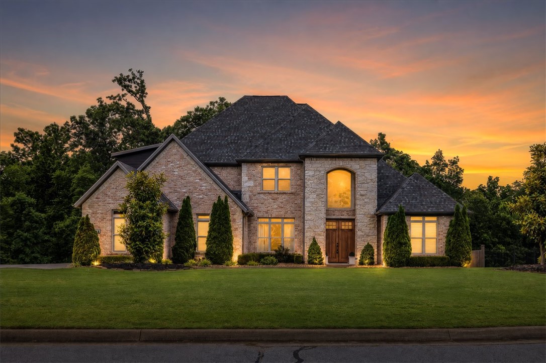 Experience the prestige of Versailles from this exceptional custom home situated on 1.84 private acres. Offering 4,966 square feet of living space, this home balances elegance, comfort, and versatility. The chef’s kitchen is the heart of the home, featuring two oversized islands, top-of-the-line appliances, abundant cabinetry, and ample space for entertaining. The open-concept layout flows into a cozy living room with a gas fireplace, while a second living area with its own gas fireplace provides additional space to relax and gather. The main level includes a luxurious primary suite and an en-suite guest bedroom.  Upstairs, you'll find a spacious lounge opening to a private patio and a media/flex room offers endless possibilities to suit your needs.  Enjoy luxury living on a quiet cul-de-sac with convenient access to Northwest Arkansas' major employers, schools, dining, shopping, and all the amenities the region has to offer. *seller is offering a 1% incentive towards buyers closing costs with preferred lender*