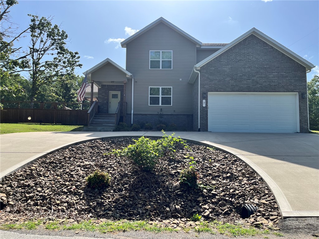 Built in 2022, this beautiful 3 bedroom, 3 full bath home sits on nearly half an acre on a secluded, level lot in Bella Vista, just minutes from the Back 40 Trail system, shopping, dining, and schools. The open floor plan offers abundant natural light, luxury vinyl plank flooring, and a propane gas fireplace. The kitchen features granite countertops, stainless steel appliances, a walk-in pantry, and a spacious dining area. The main-level primary suite includes dual vanities, a soaking tub, a walk-in tiled shower and a large walk-in closet. The back yard features a covered patio to enjoy in the privacy fenced backyard.  This well-maintained home offers a functional layout, modern finishes, attic storage and large additional room area over the garage that could be used as an extra bedroom/guest room, office space or theater room.