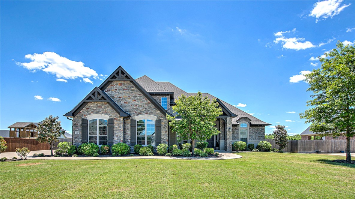 Tucked within the established Otter Creek community, this thoughtfully designed Buffington home offers a refined yet comfortable living experience. The Alexandria plan features custom cabinetry, striking finishes, and a functional split layout that supports both everyday living and privacy. A spacious media room is ideal for movie nights or entertaining, while a dedicated office provides a comfortable work-from-home space. The main living areas flow easily, creating a welcoming setting for gatherings and daily life. Step outside to an inviting outdoor space with a fireplace, perfect for enjoying Northwest Arkansas evenings. Neighborhood amenities include a clubhouse, pool, park, and sports court. Evening Star Elementary School is approximately 4.1 miles away.