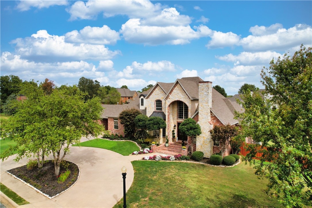 Stunning estate on nearly an acre in gated St. Valery Downs! Prime location near Bentonville/Rogers--short walk to Central Park Elementary. This beautifully landscaped, elegant, yet inviting home features beams, fireplaces, large windows, curved staircase & endless storage--upstairs game room w/wet bar & patio. Enjoy the cozy den w/fireplace. A chef’s kitchen offers island w/ sink, ample cabinets, built-in GE Monogram appliances & Viking 6-burner stovetop. All 4 roomy bedrooms have ensuite baths--2 on 1st floor. Primary suite boasts luxurious bath, double shower & vanities & custom-built spacious closet. Additional room could serve as office/exercise room. Multiple outdoor areas for entertaining include bar/sink area for watching the big game/ wood-burning fireplace for relaxing while cozying up on the porch swing/heated pool for swimming/ hot tub for soaking while taking in the beautiful NWA night sky—added amenities built-in grill & outdoor bathroom. Corner lot w/ oversized 2-car & single-car garage.